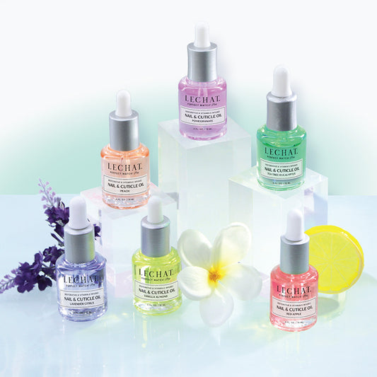 Collection of Lechal nail and cuticle oils on a light background with flowers.