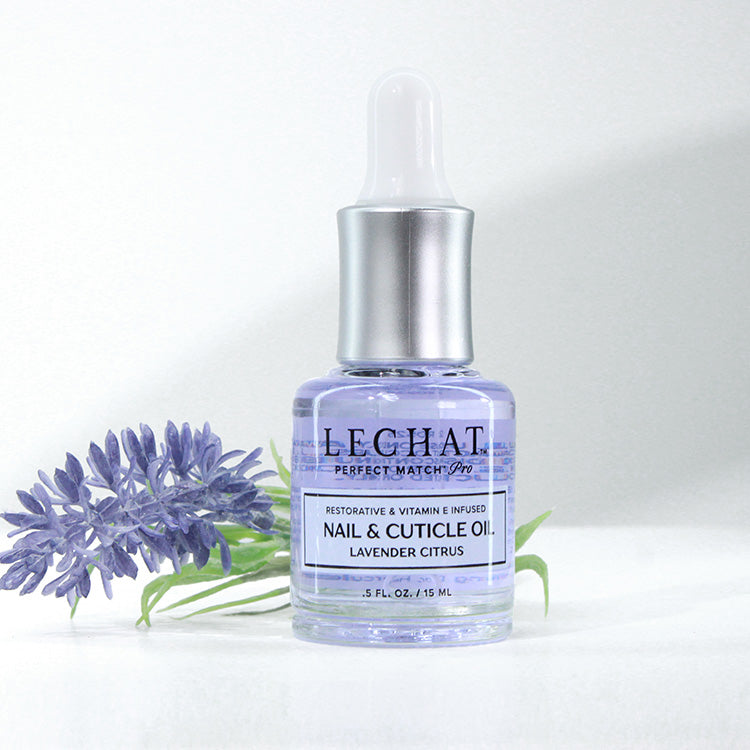 LECHAT nail and cuticle oil bottle with lavender flowers on a white background