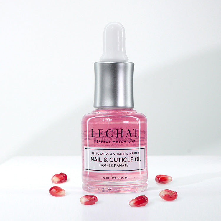 Pink nail and cuticle oil bottle with dropper on a white background