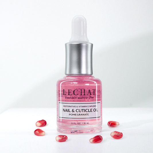 Pink nail and cuticle oil bottle with dropper on a white background