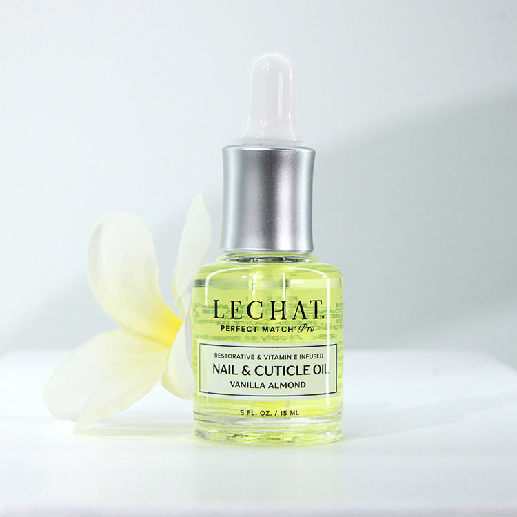 Bottle of LeChat nail and cuticle oil with a dropper on a white background